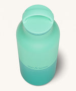 A close up of the Klean Kanteen 20oz Classic rise cabbage insulated classic reusable steel water bottle showing the handle detail on the light green loop cap