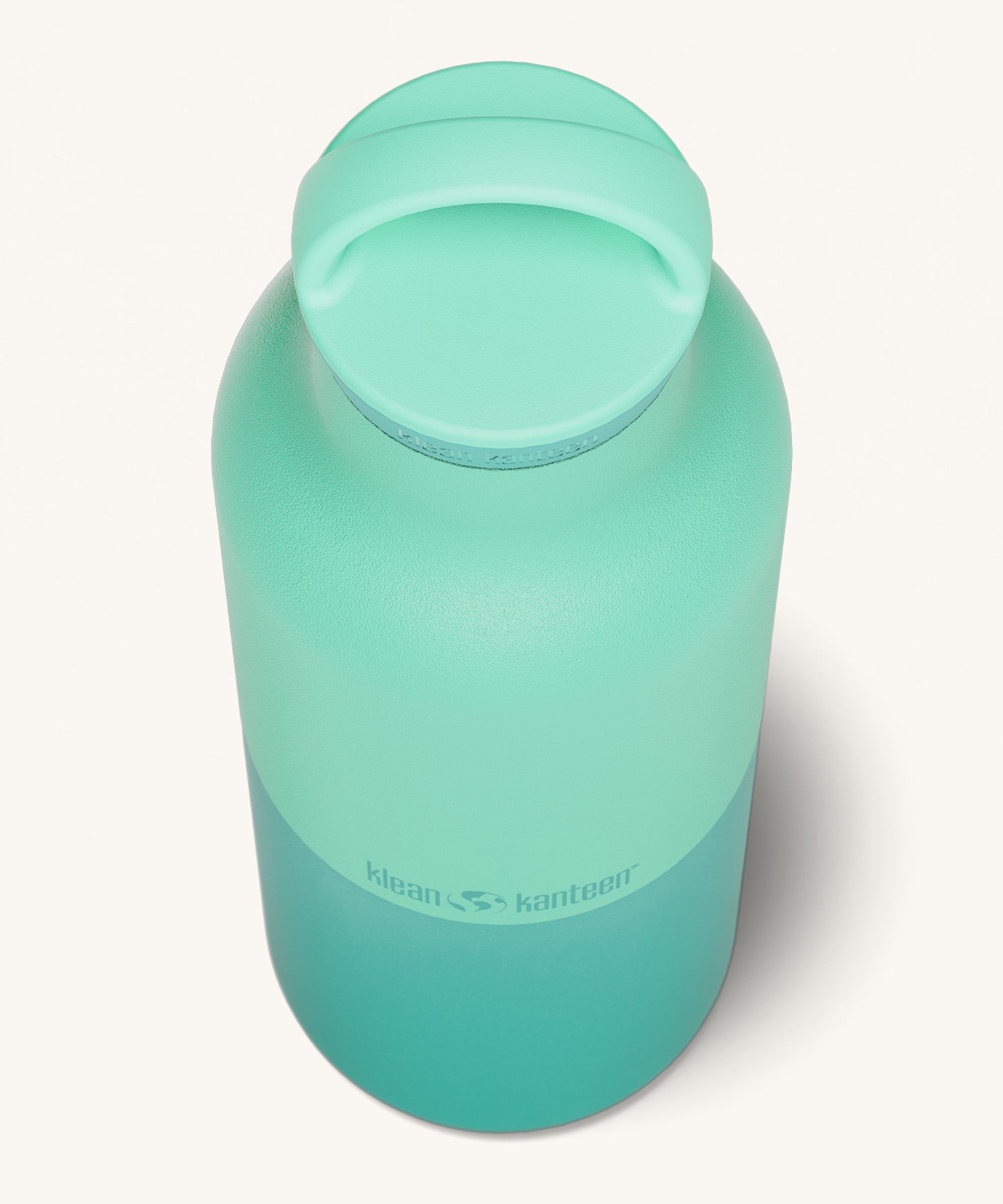 A close up of the Klean Kanteen 20oz Classic rise cabbage insulated classic reusable steel water bottle showing the handle detail on the light green loop cap