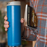 A close up of a person holding the cosiar blue coloured Klean Kanteen 20oz TKWide Cafe in their hand.