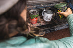 Close up of woman pouring some water into the Klean Kanteen 12oz eco-friendly metal camping mug