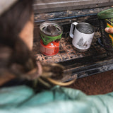 Close up of woman pouring some water into the Klean Kanteen 12oz eco-friendly metal camping mug