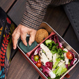 Person wearing a tweed jacket having lunch from the Klean Kanteen Rise Stainless Steel Big Meal Box with divider