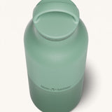 A close up of the Klean Kanteen 20oz Classic rise iceberg insulated classic reusable steel water bottle showing the handle detail on the green loop cap