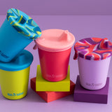 4 Klean Kanteen kids 10oz steel drinks cups with the removable sippy lid on a purple background