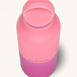 A close up of the Klean Kanteen 20oz Classic rise pink lemonade insulated classic reusable steel water bottle showing the handle detail on the pink loop cap