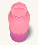 A close up of the Klean Kanteen 20oz Classic rise pink lemonade insulated classic reusable steel water bottle showing the handle detail on the pink loop cap