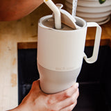 A close up of a person filling up a Tofu coloured Klean Kanteen Limited Edition 36oz Rise Tumbler with water from a tap