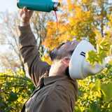 Man tipping his head back and pouring liquid from a Klean kanteen stainless steel pour through bottle into his mouth