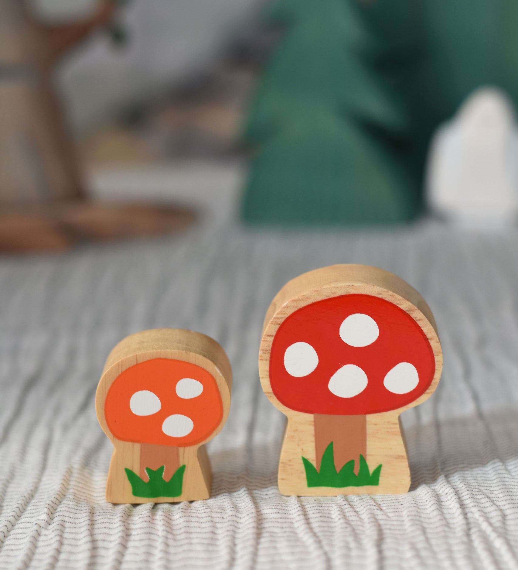 Lanka Kade orange and red spotted toadstool placed on a striped tablecloth.