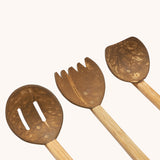 A close up of the three utensils included in the Lanka Kade Coconut Shell Sand Playset.