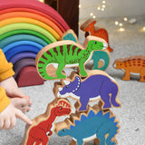 A stack of Lanka Kade wooden toy dinosaur figures. These wooden toy figures are part of a huge range of Lanka Kade fair trade, wooden toys available here at Babipur.