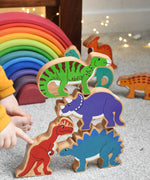 A stack of Lanka Kade wooden toy dinosaur figures. These wooden toy figures are part of a huge range of Lanka Kade fair trade, wooden toys available here at Babipur.