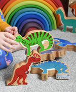 A child stacking Lanka Kade dinosuar figures. These wooden toy figures are part of a huge range of Lanka Kade fair trade, wooden toys available here at Babipur.