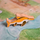 A Lanka Kade icthyosaur placed on a Wonderie play cloth. These wooden toy figures are part of a huge range of Lanka Kade fair trade, wooden toys available here at Babipur.