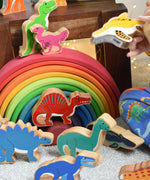 A child playing with the Lanka Kade wooden dinosaur figures. These wooden toy figures are part of a huge range of Lanka Kade fair trade, wooden toys available here at Babipur.