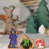Lanka Kade witch, cauldron and toadstool figures placed at the front of a small world play scene.