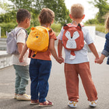 Children holding hands, all wearing Lassig 'About Friends' tiny ids backpacks with different animal styles.