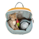 A top view of the Lassig 'About Friends' tiny kids backpack in a lion style, with a stuffed cuddly deer, a toy, and a water bottle inside.