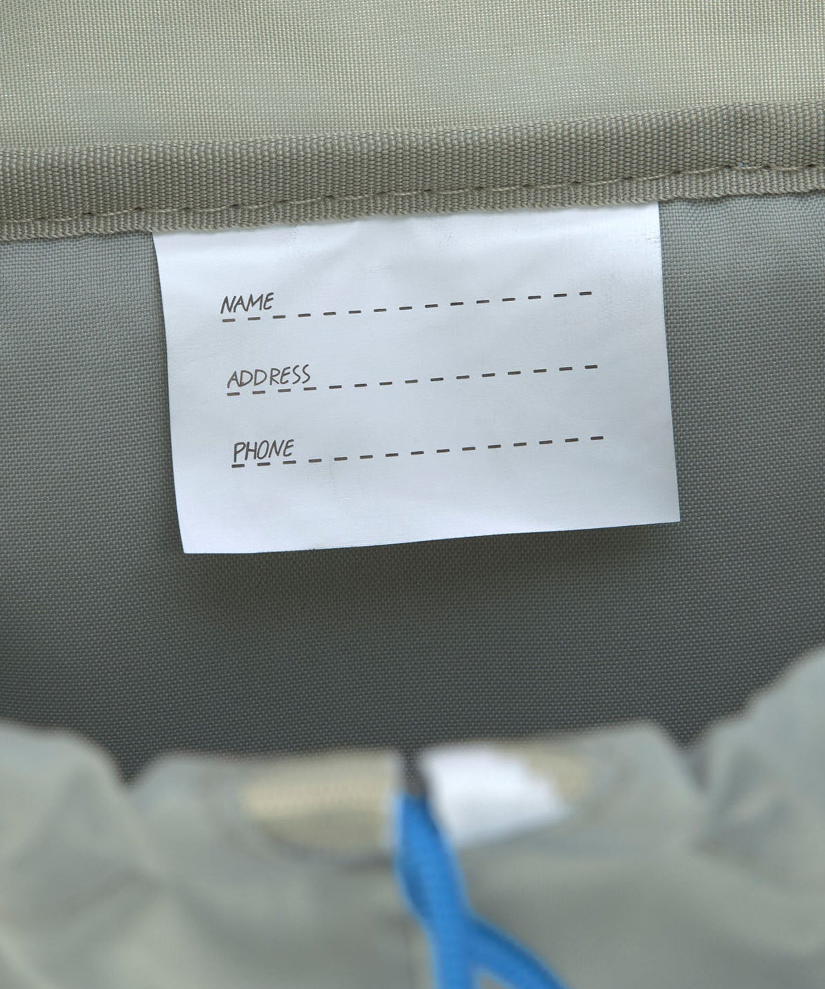 A close up of the name tag on the Lassig kids mini outdoor backpack.