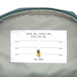 The inside label of the Lassig mini backpack for kids in a dark green colour, with multiple spaces for names and addresses so the bag can be passed on to younger siblings and friends.