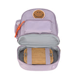 The Lassig mini kids backpack in a lilac colour, with the bottom zippered compartment open to show that you can use it to store a lunch box.