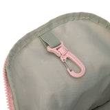 The inside of the Lassig kids mini backpack in a Safari Giraffe pink print, showing the handy hook that can be used for little items such as keys.