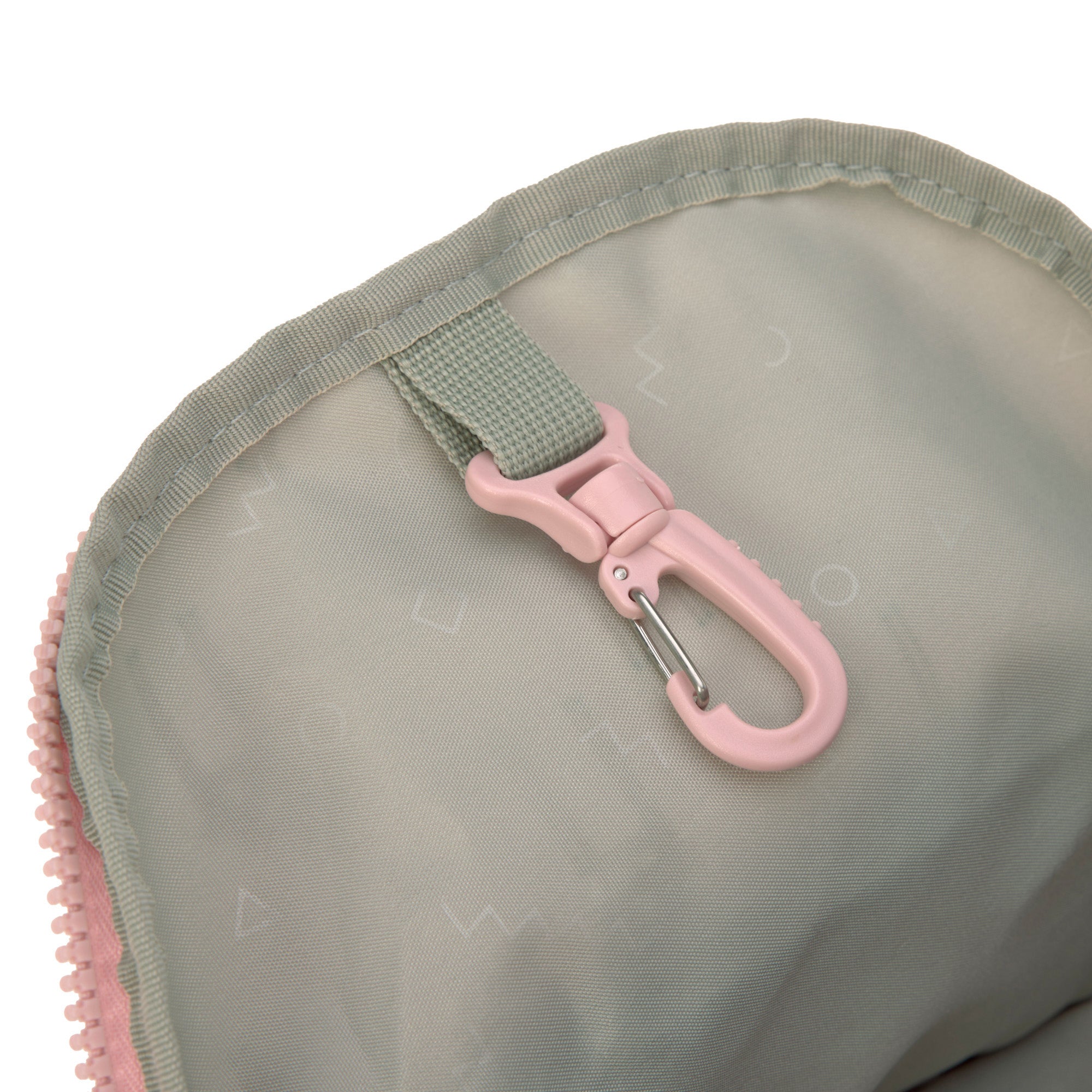 The inside of the Lassig kids mini backpack in a Safari Giraffe pink print, showing the handy hook that can be used for little items such as keys.