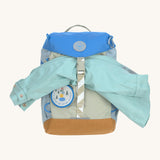 Lassig kids mini outdoor backpack in sunny explorer green holding a raincoat.