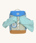 Lassig kids mini outdoor backpack in sunny explorer green holding a raincoat.
