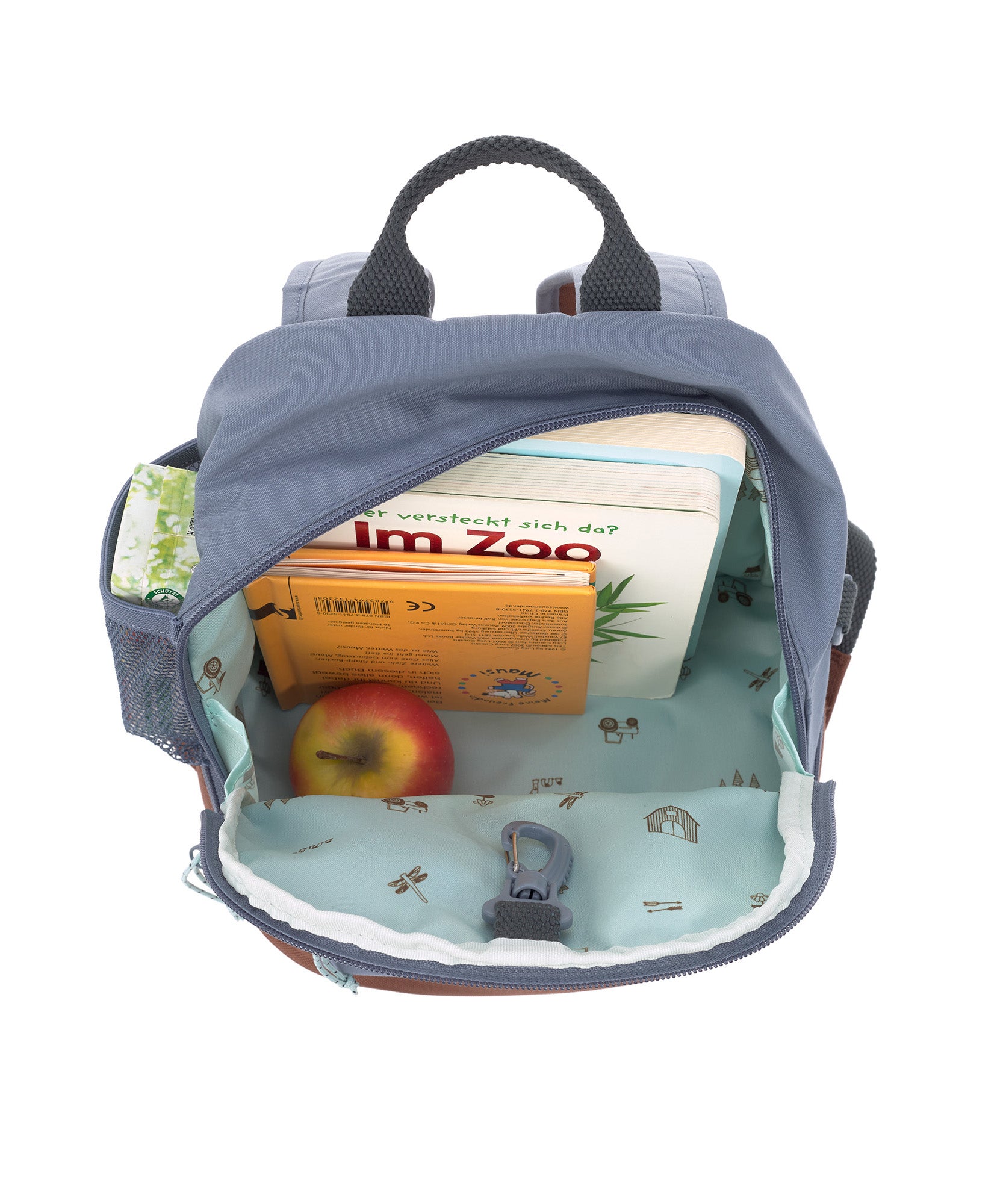 A view of the inside of the Lassig Kids Mini Backpack, showing the vast storage space and tractor pattern inside.
