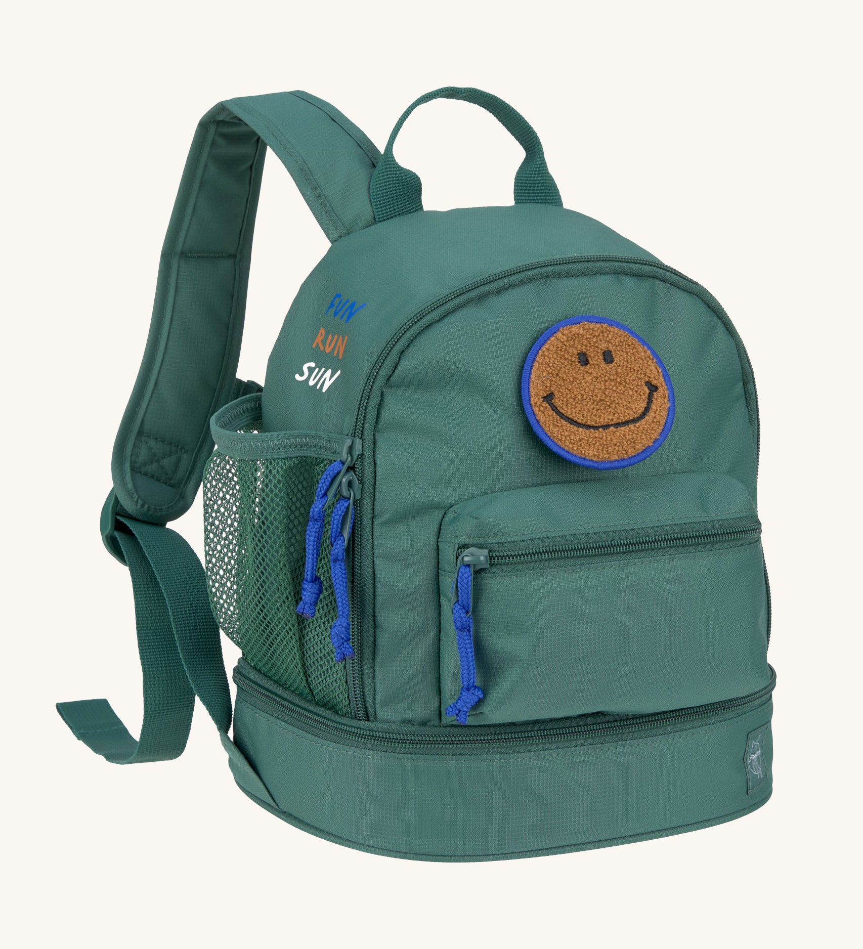 The Lassig mini backpack for kids in a dark green colour, with blue zips and a smiley face patch.
