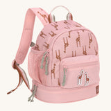 A Lassig mini backpack for kids in light pink, with giraffes printed all over.