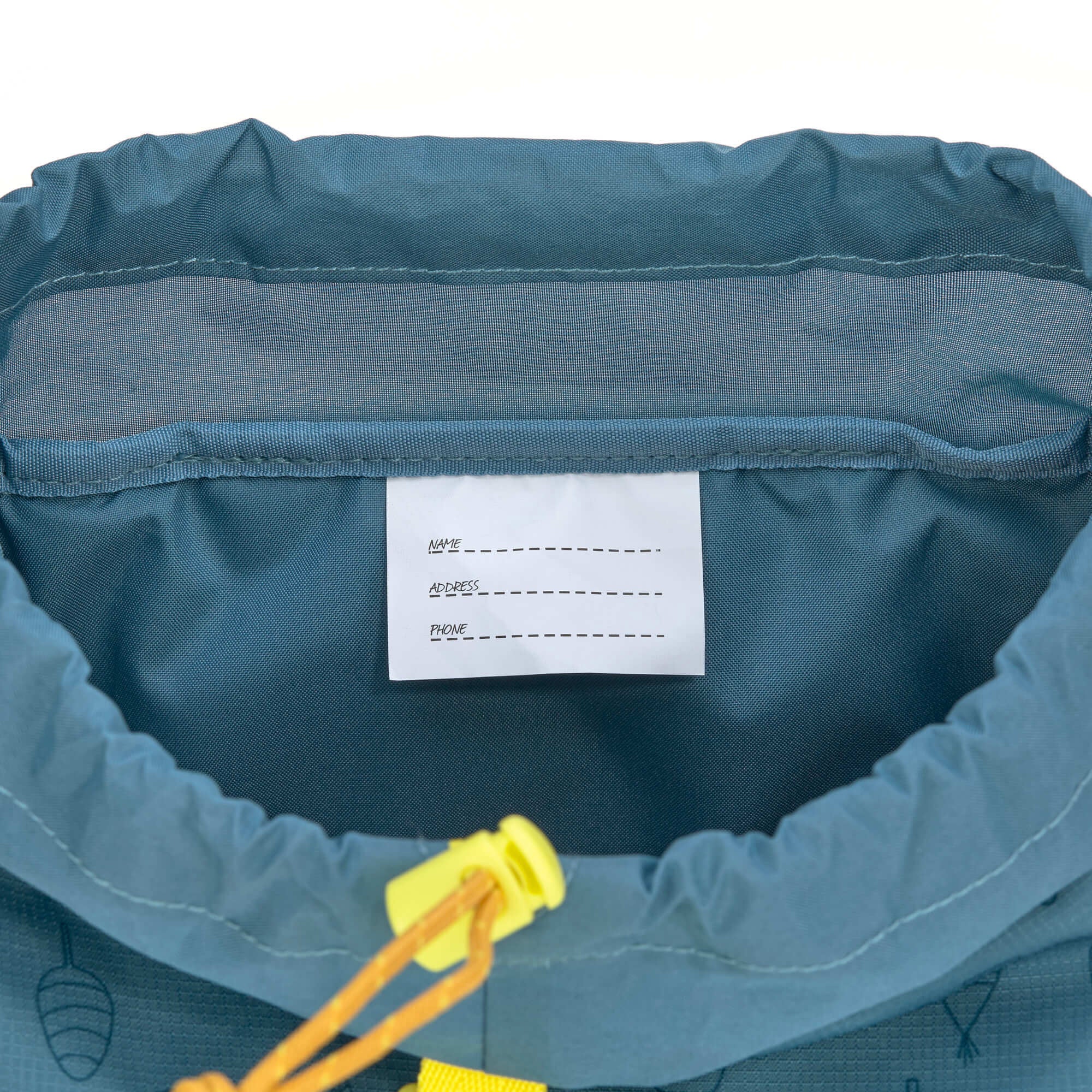 The inside name label of the Lassig kids mini outdoor backpack in Adventure Blue.