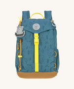 The Lassig kids mini outdoor backpack in Adventure Blue, with a print featuring tents, trees, and clouds, and a neon green front strap.