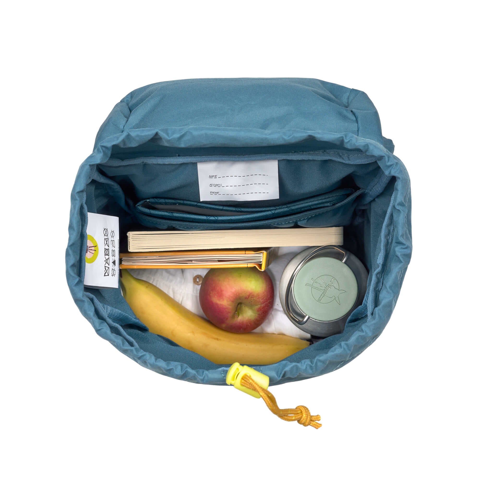 A top view of the inside of the Lassig kids mini outdoor backpack in Adventure Blue, with some fruits, a water bottle, and some books inside.
