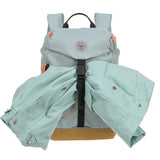 The Lassig kids mini outdoor backpack in blue, with a coat secured under the front strap.