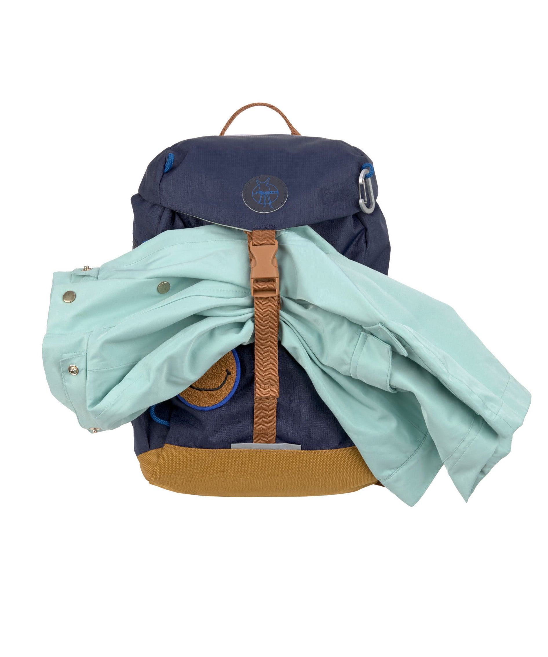 The Lassig kids mini outdoor backpack in navy blue, with a coat secured under the brown strap.