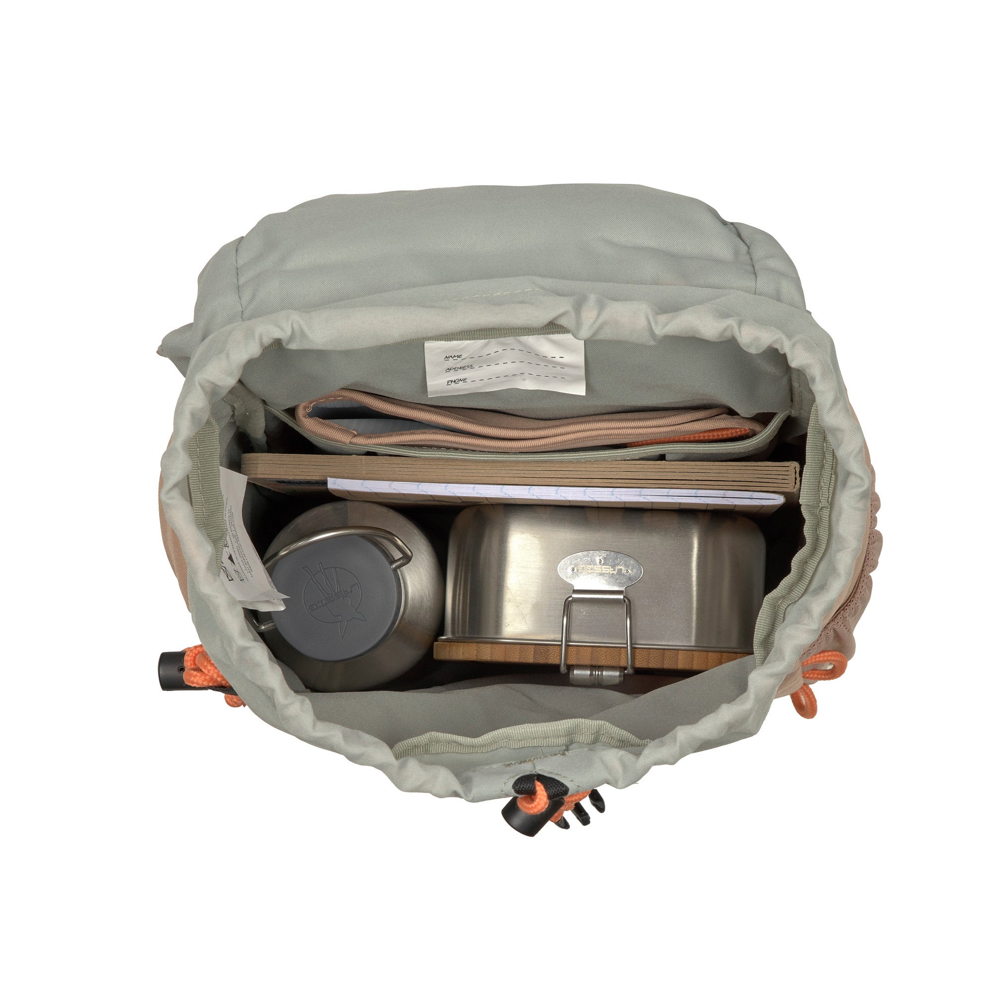 A top view of the Lassig kids mini outdoor backpack in a hazelnut light brown colour, showing the capacity with a lunchbox, a water bottle, and some books inside.
