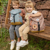 Two children holding their Lassig kids mini outdoor backpack in hazelnut and blue colours.