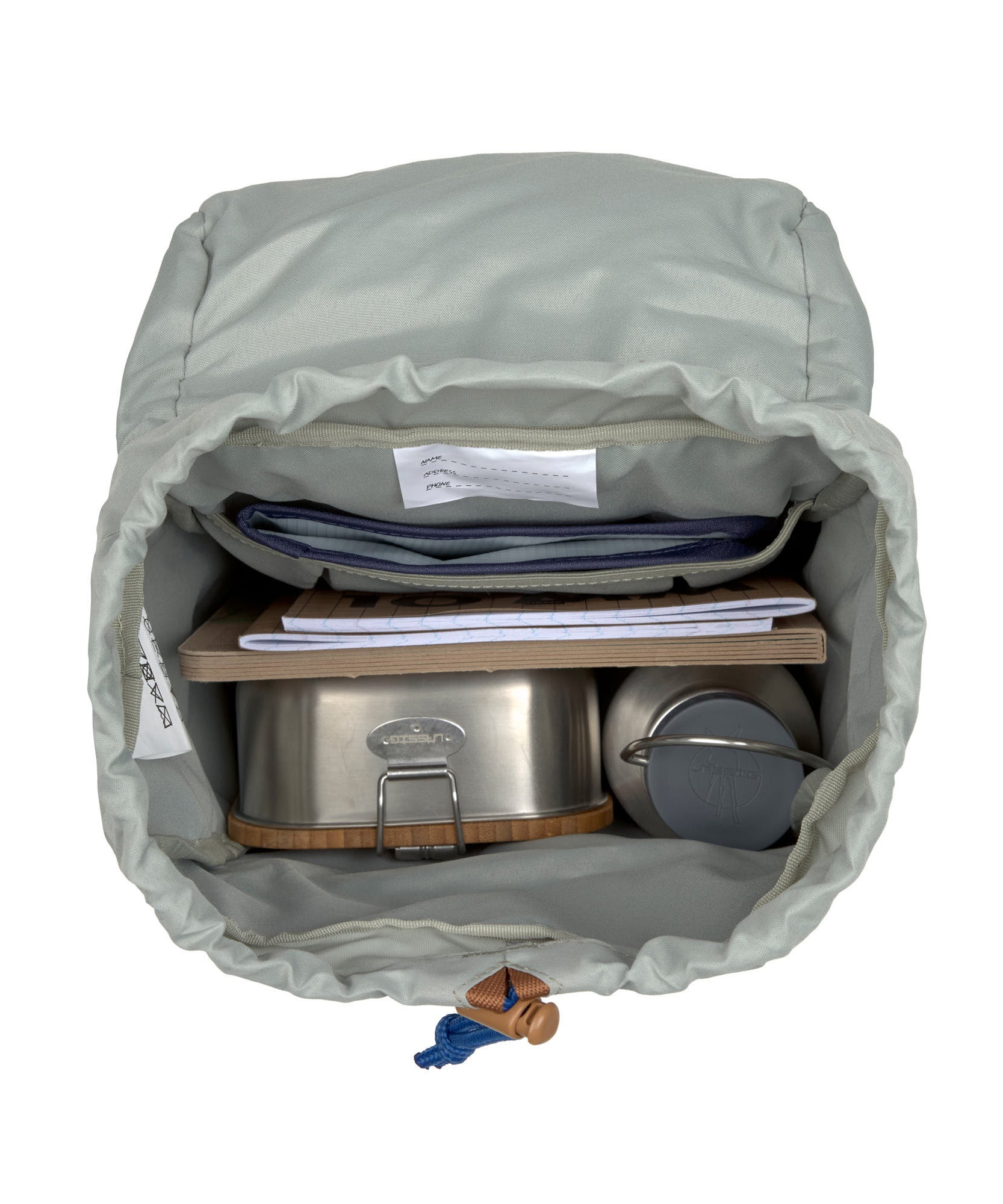 A top view of the inside of the Lassig kids mini outdoor backpack, showing that it has space for a lunchbox, water bottle, and school books.