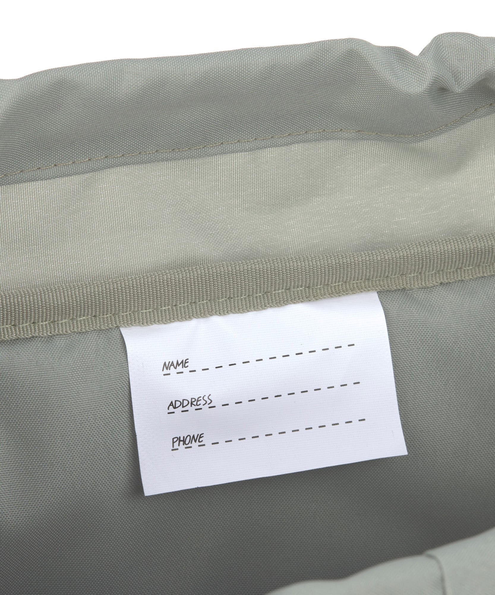 A closeup of the name label inside the Lassig kids outdoor mini backpack.