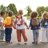 A group of children holding hands, all wearing different 'About Friends' tiny backpacks from Lassig with different animals.