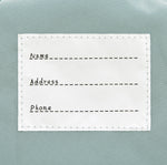 The inside label of the Lassig 'About Friends' tiny backpack in light pink.