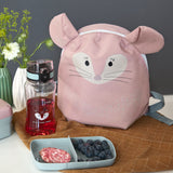 The Lassig 'About Friends' tiny backpack in light pink, with a chinchilla face and 3D ears, on a table next to a lunch box and water bottle.