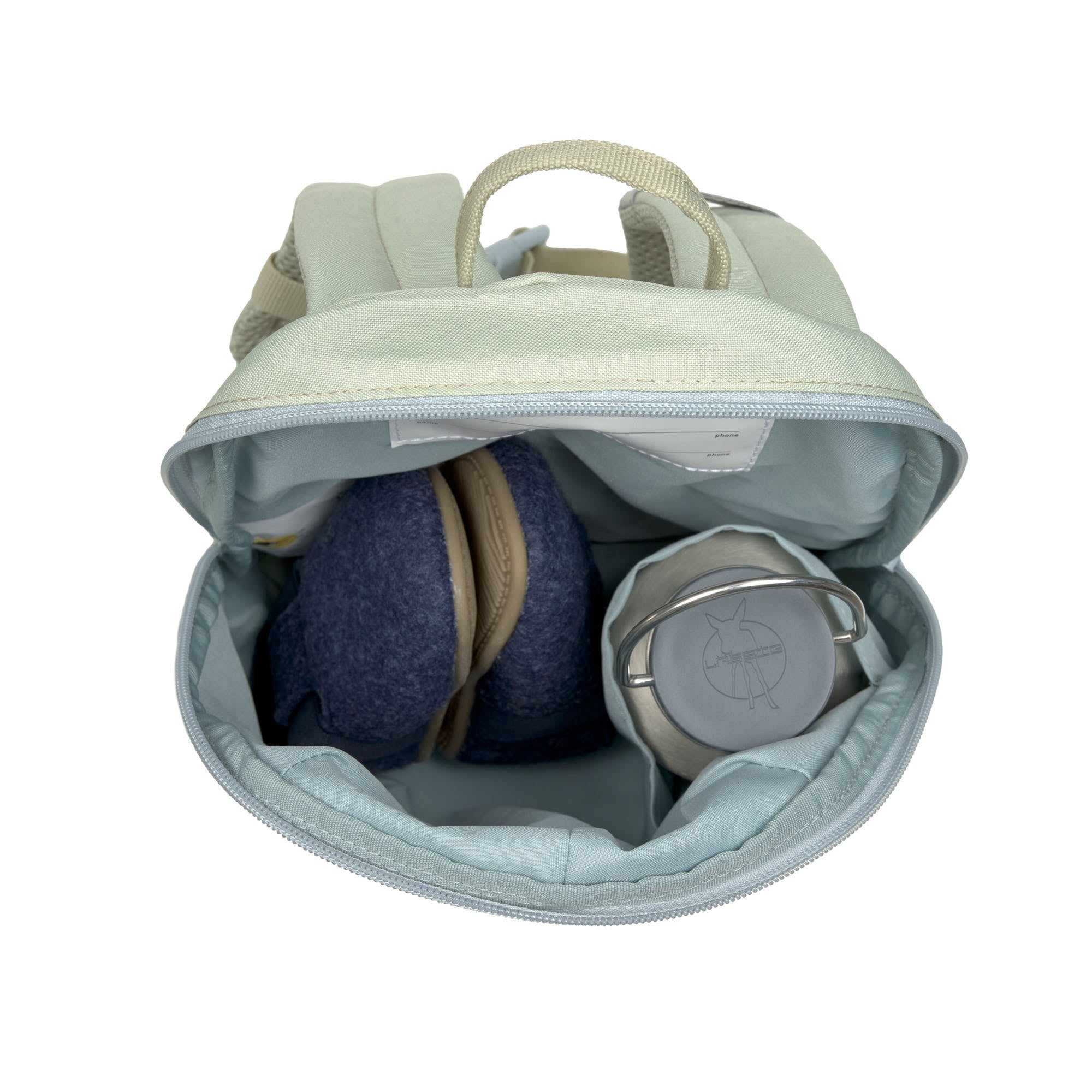 A top view of the Lassig tiny kids backpack in a pale blue-green, showing the storage space with a pair of shoes and a water bottle inside.