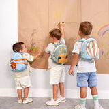 A group of kids wearing the aeroplane, digger and balloon character tiny Lassig backpacks.