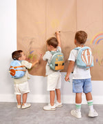 A group of kids wearing the aeroplane, digger and balloon character tiny Lassig backpacks.