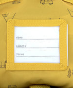 The name label on the inside of the Lassig kids mini campervan backpack, with a yellow lining with a campervan pattern.