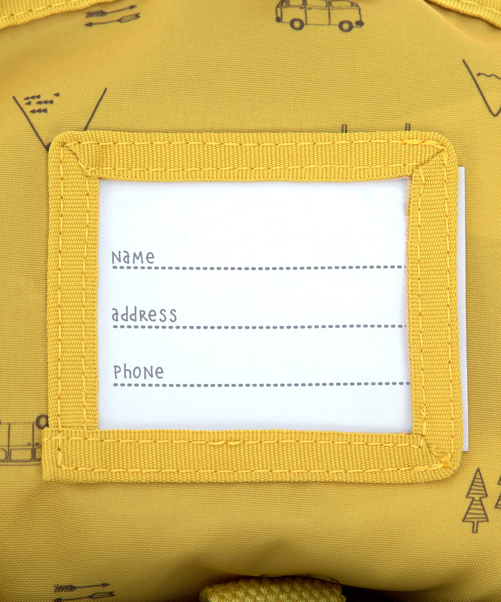 The name label on the inside of the Lassig kids mini campervan backpack, with a yellow lining with a campervan pattern.