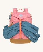 Lassig kids mini adventure backpack in rose holding a rain coat inbetween the buckle fastener.